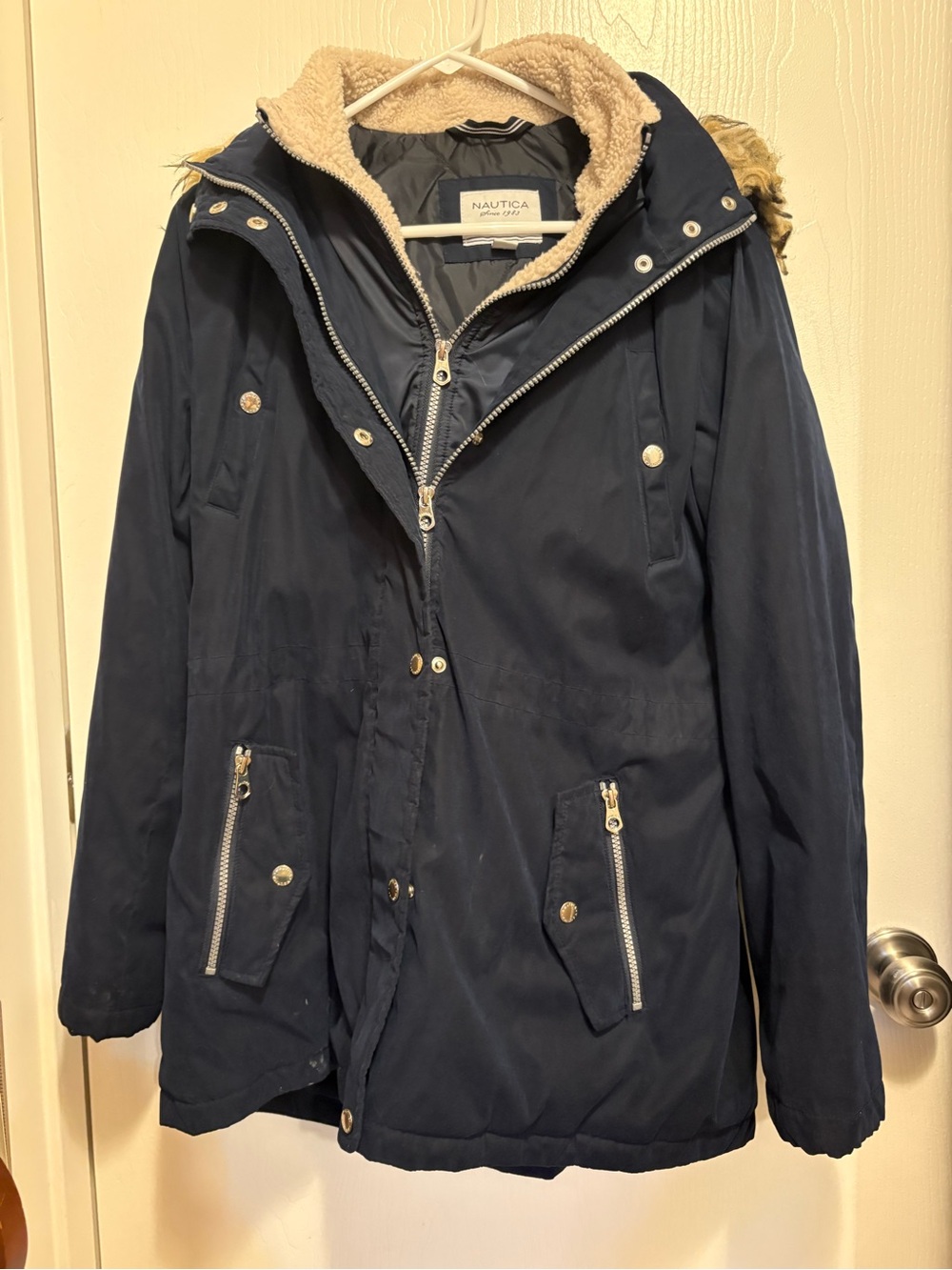 Nautica heavy double zip/button closure and front pockets. Attached hood.